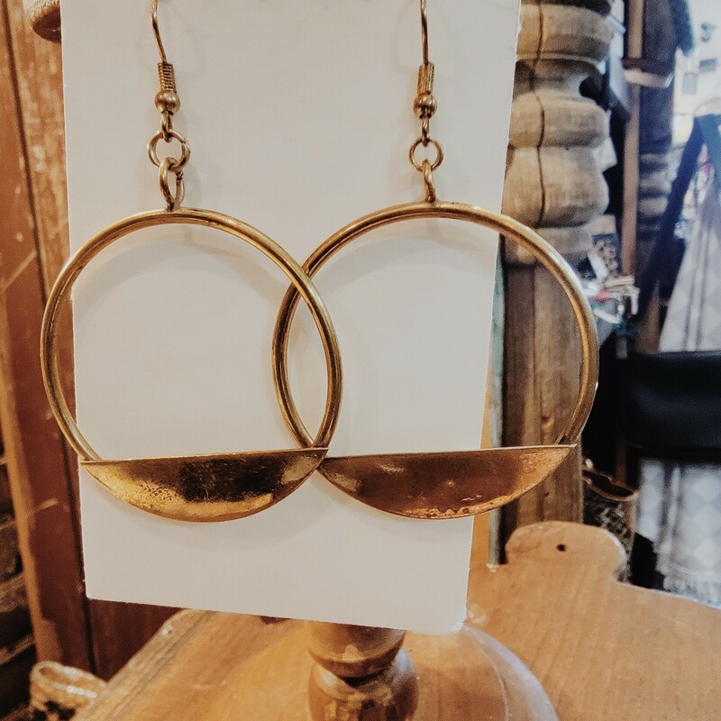 Metal Gold Circle Earrings with a solid piece of metal at the bottom of the earring. Measuring 3 inches long.