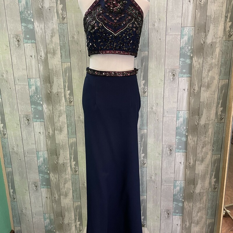Sherri Hill 2 Piece Formal<br />
Beautifully beaded with a low cut back waistline and flaired skirt that is longer in the back<br />
Navy and purple<br />
Size: 6<br />
NO RETURNS ON PROM DRESSES