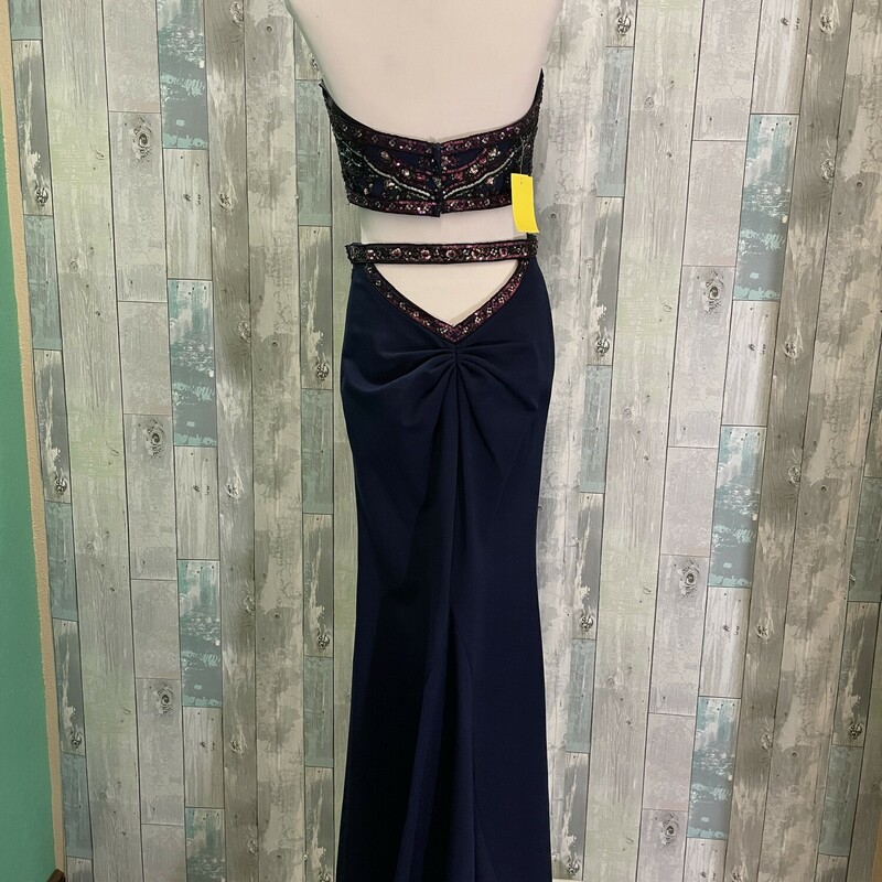 Sherri Hill 2 Piece Formal<br />
Beautifully beaded with a low cut back waistline and flaired skirt that is longer in the back<br />
Navy and purple<br />
Size: 6<br />
NO RETURNS ON PROM DRESSES