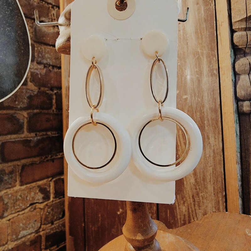 These earrings are simple but cute. They have a cream button at post that is connected with a gold oval ring and that is connected by a cream circle with a smaller gold circle. These are light weight. 3 long.