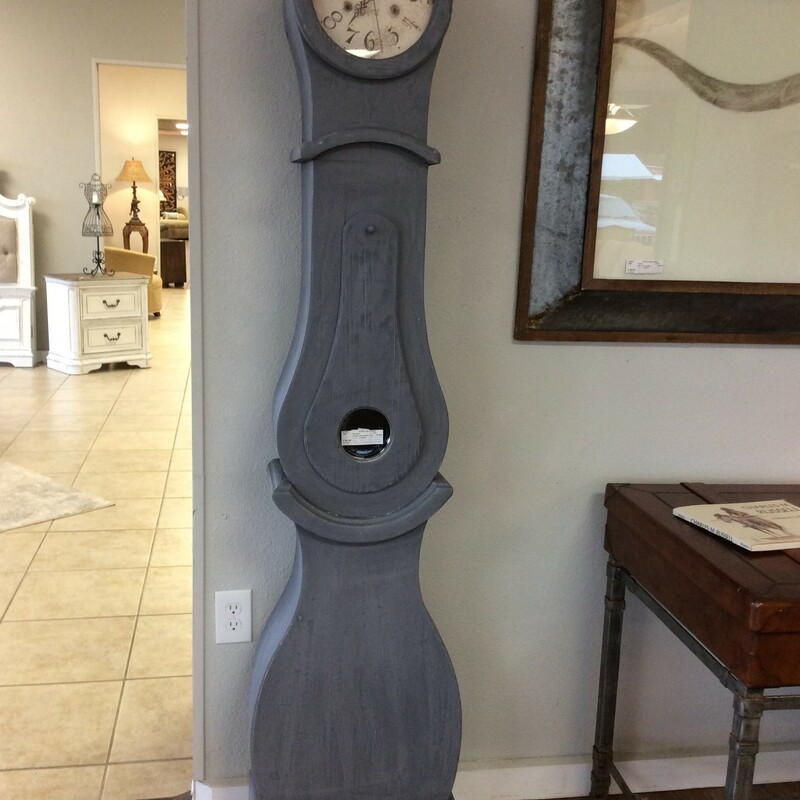This custom-made grandfather clock has been painted gray and distressed. It includes a hidden compartment.