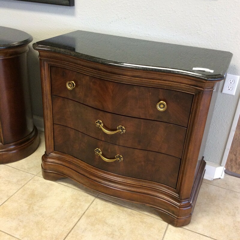 This is a beautiful nightstand by American Drew's Bob Mackie Collection. It features a dark wood finish with a marble top and 3 drawers. We have 2 of them priced separately.