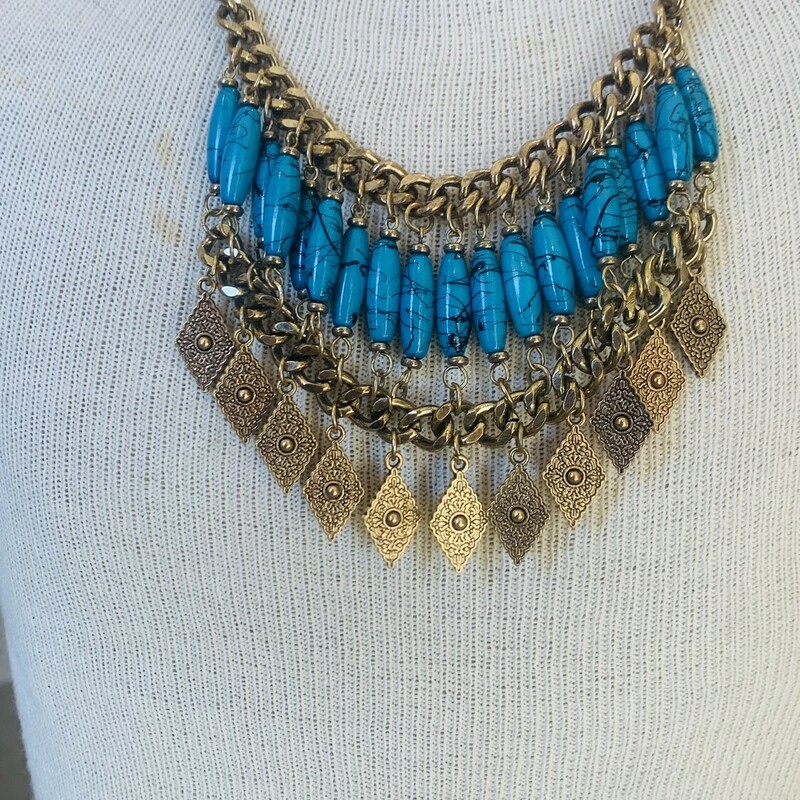 Goldie Locs Necklace, composed of bheavy golden chain and turquoise beads. Measuring 18 inches and a 3 inch extension clasp.