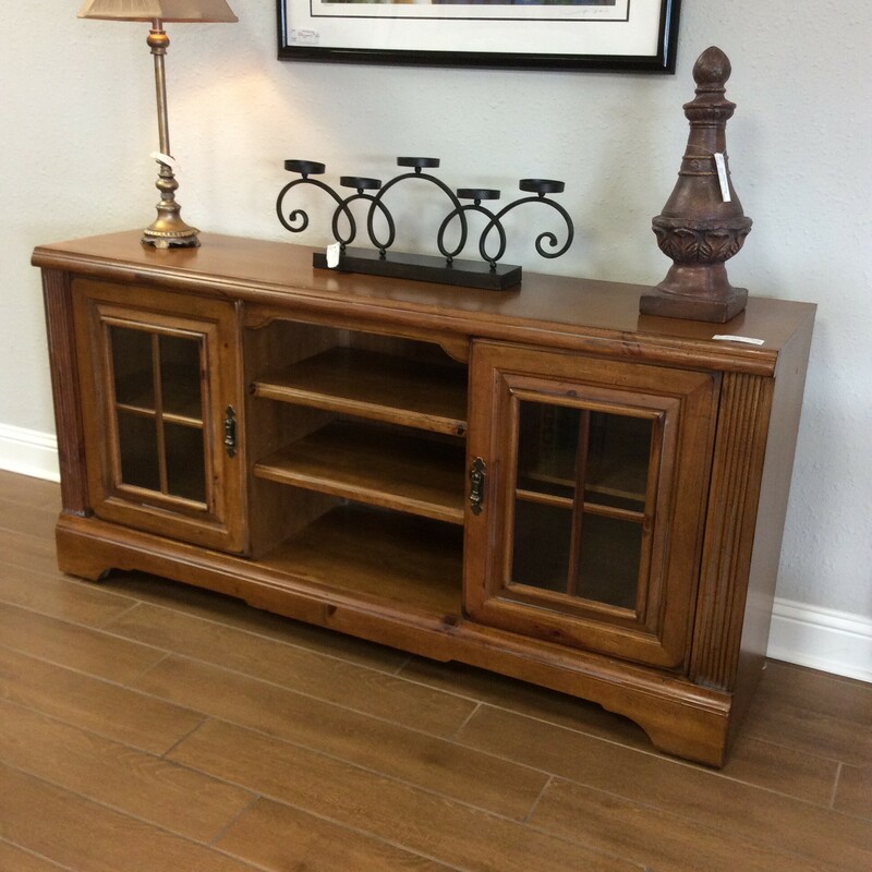 This media cabinet features an oak wood finish, adjustable shelving and 2 cabinets.