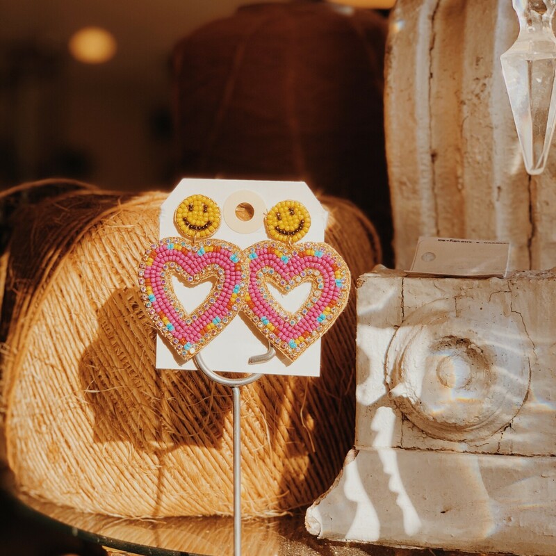 These fun and cheery earrings are sure to make you smile! They have a smiley face stud post with a heart hanging from it, and they are completely beaded.
Measurements: about 2.25 inches long