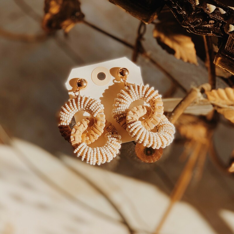 These adorable earrings are made from wicker and have white beads adorning them! They measure 3 inches long.