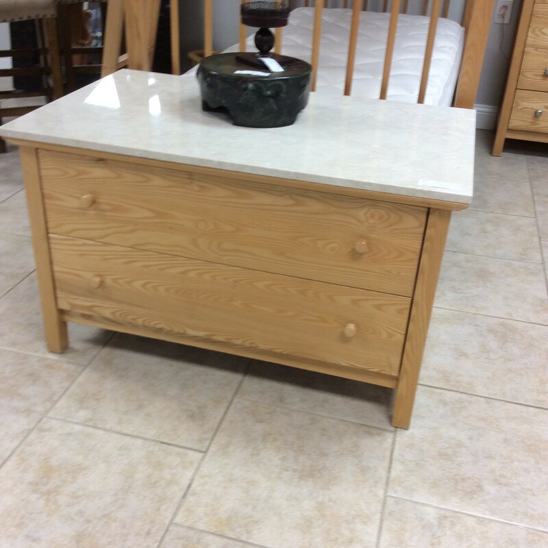 This lowboy chest feaures a light wood finish, 2 drawers and a marble top.