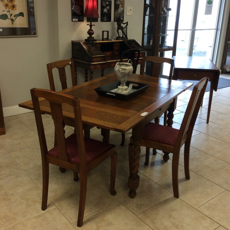 This small dropleaf table features a darkwood finish and barley twist legs. The set of 4 chairs have a marroon upholstered seat.