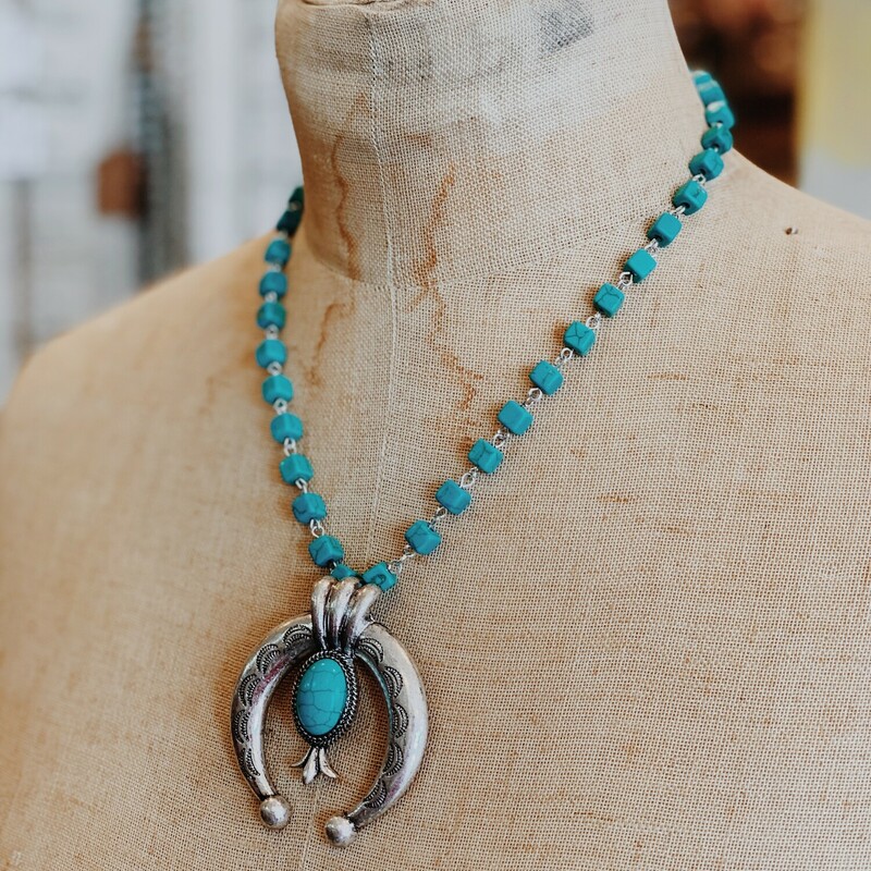 The pendant on this beauty! The cresent shape is such a classic look, and it looks even better on this turquoise chain!