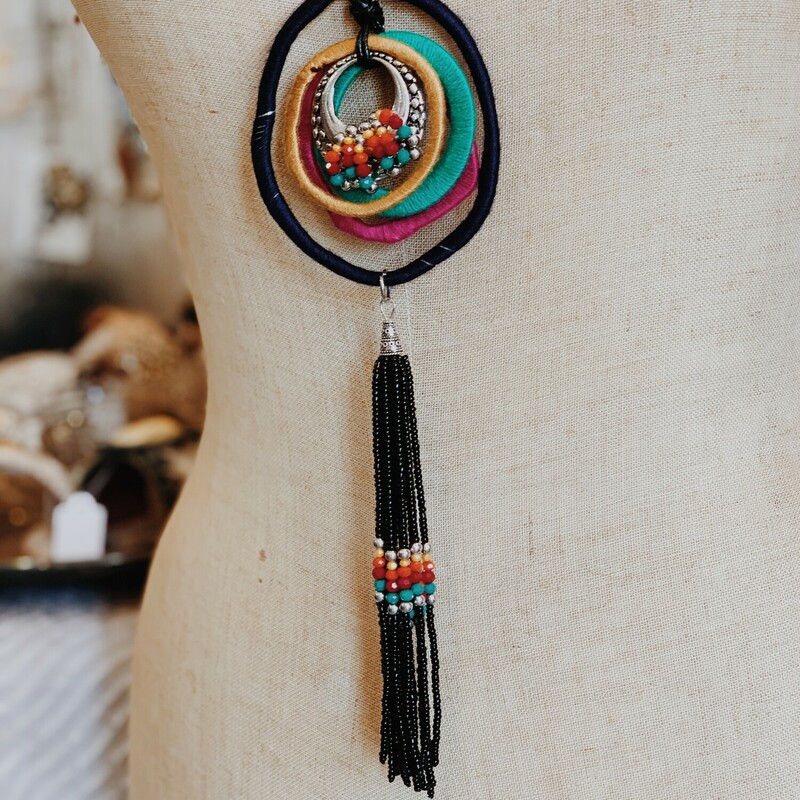The perfect way to top off an outfit! The deep tones in this necklace are beautiful! measuring 24 inches long with beaded tassle pendant.