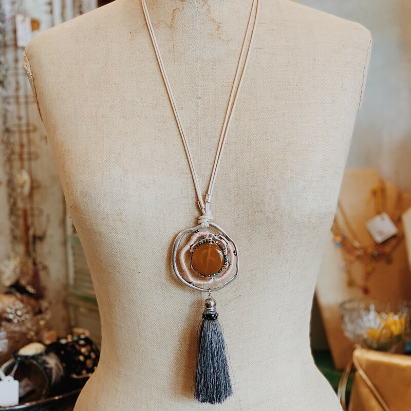 This is the perfect layering necklace! Adorable pendant and tassle. Measuring 21 inches including tassle pendant.