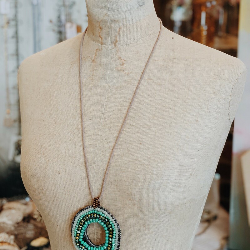 The large beaded pendant on this necklace is such an eye catcher! The necklace measures 18 inches long including the pendant.