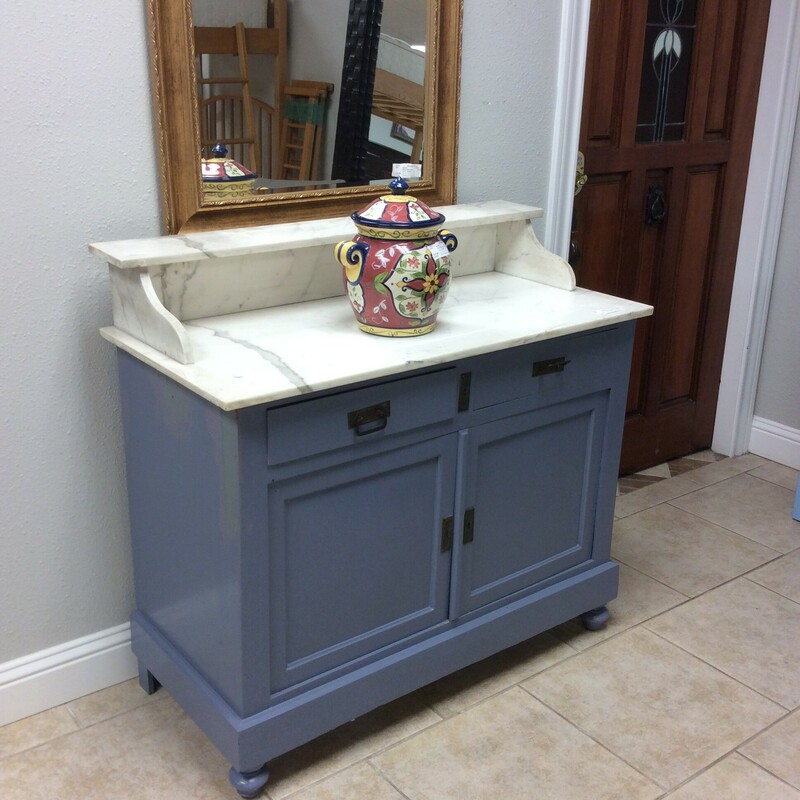 This washstand has been painted a soft blue and has a marble top. Key included.