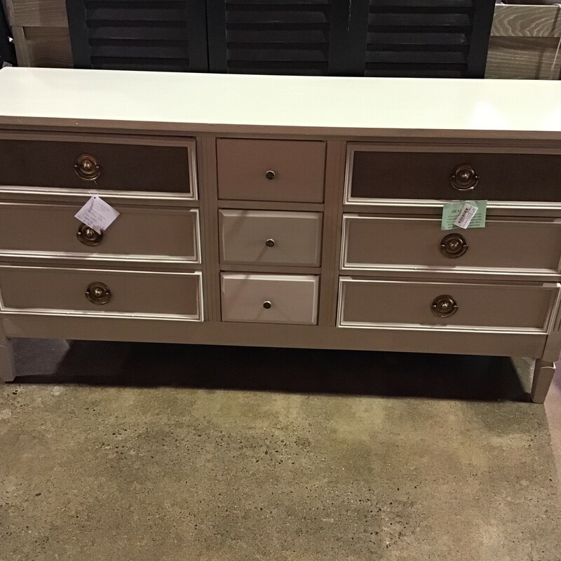 Another beautfully painted piece by our Local Artist!  This 9 drawer dresser has been painted with Country Chic Sunday Tea paint and then clear waxed.  The top has three coats of Polyurethane for added durability.  Two of the drawer fronts have been covered with burlap for additional charm!

Dimensions: 62x18x31