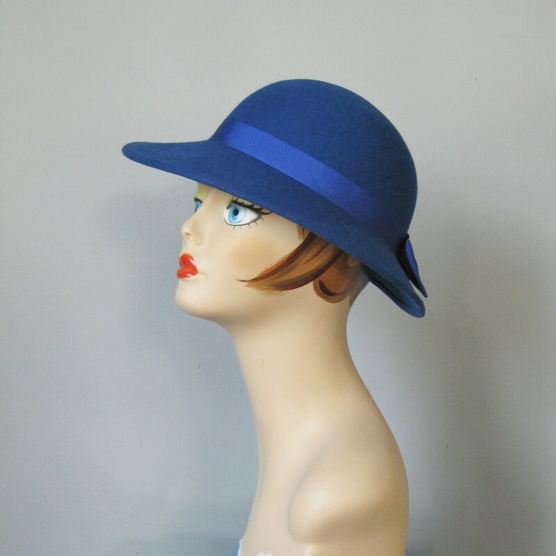 Channel Lady Diana in the royal purply blue bowler hat
100% wool, made in the USA
it has a wide-ish brim with a big bow at the back
inner hat band measures 20 around.  My mannequin's head measure about 20.5 inches around, if your head is bigger this hat will sit a little higher on you than on her.

Excellent condition
thanks for looking!
#45290