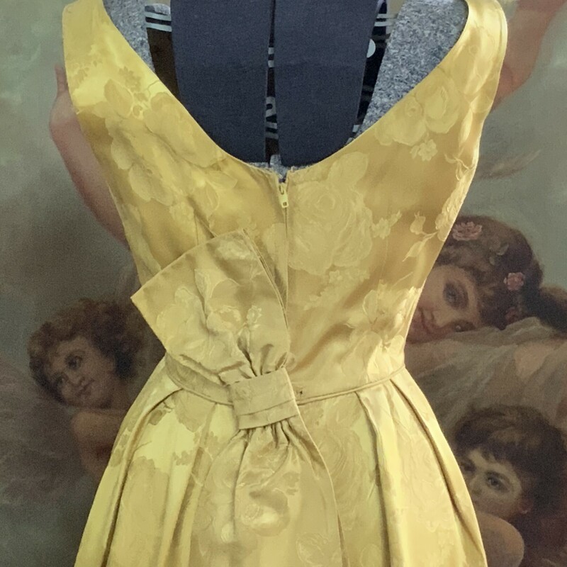 Stunning 1950s Gold Cocktail Dress Tag reads The Elaine Shop Jackson
Beautiful damask fabric Bow detail on back   Size XS  35 inch long  23 inch waist 32 inch bust  15 inch shoulders.