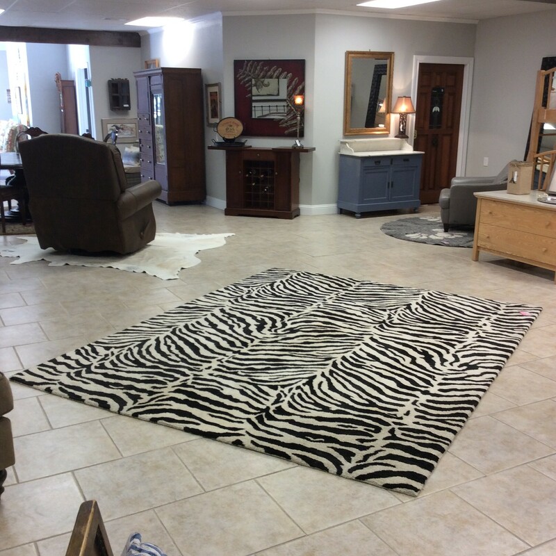 This area rug features a black and white zebra pattern.