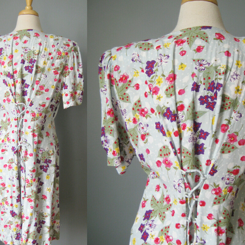 Vtg Jamie Brooke Floral, Blue, Size: 18<br />
Pretty floral rayon dress from the late 80s or early 90s.<br />
Pale aqua background with yellow, purple and red flowers<br />
Long fully buttondown with fabric coverd buttons and loops<br />
Short sleeves<br />
Corset lacing in the back which allows a lot of leeway as to fit.<br />
unlined<br />
LARGE shoulder pads<br />
100% rayon<br />
<br />
by Jamie Brooks<br />
marked size 18,  but please use these flat measurements:<br />
Shoulder to shoulder: 17.5<br />
armpit to armpit: 22.5<br />
waist: up to 21.75<br />
hip: 28 1/2<br />
length: 33<br />
<br />
excellent condition, except two of the buttons have lost their fabric coverings and one is a little cracked, also a little bit of fraying at the back of the neckline<br />
<br />
thanks for looking!<br />
#44286