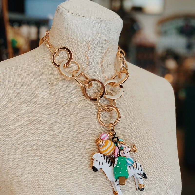 Handmade chunky gold necklace decorated with a zebra and brightly colored found objects