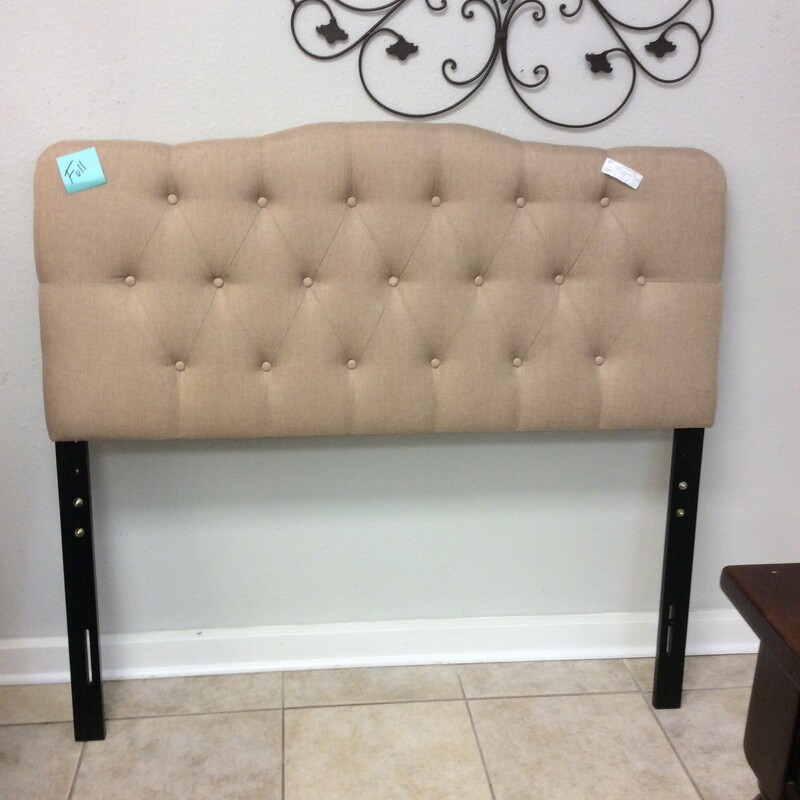 This full-size headboard includes a frame. Upholstered in tan with button-tufting. We have 2 of them.