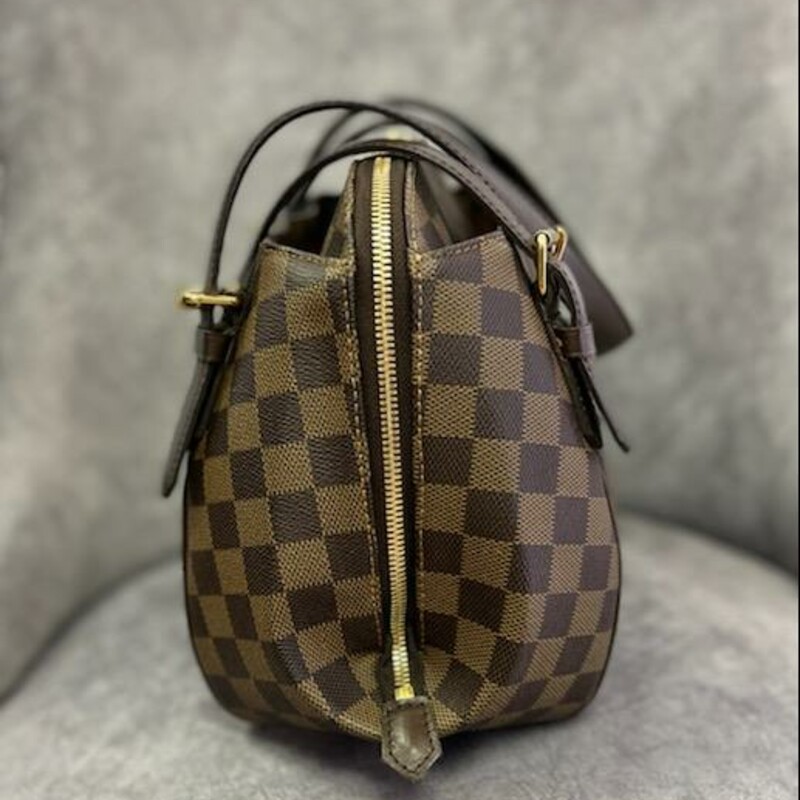 LOUIS VUITTON
Damier Ebene Belem MM
Craving a bag that is chic and feminine? This unique, curvy-shaped Louis Vuitton Damier Canvas Belem MM Bag is the one for you. It features a sleek structured design and two outer pockets for added convenience. This MM bag is the larger size of the Belem family and has the capacity to hold all your girly essentials and definitely will not cramp your style.
The original Louis Vuitton Damier Canvas was originally created in 1888 and was relaunched in 1996 with an entire collection of handbags and small leather goods. Its unique geometric pattern and understated elegance makes this a LV classic and timeless collection.
This stylish shoulder bag is crafted of Louis Vuitton's signature Damier checkered canvas in ebene brown. The bag features high patch pockets on front and back and dark brown leather straps with brass anchors. The top wrap-around zipper opens to an interior of red fabric interior.
Size (HxWxD): 24cm x 34cm x 15cm / 9.44'' x 13.38'' x 5.9''
Strap Length: 62.5cm / 24.6''
This is in like new condition.  Spotless inside and no exterior flaws.
Comes with CERTIFICATE of AUTHENTICITY
In this similar condition \"Rebag\" has this bag for $1665.00 & \"Tradesy\" is selling it for $1759.00.