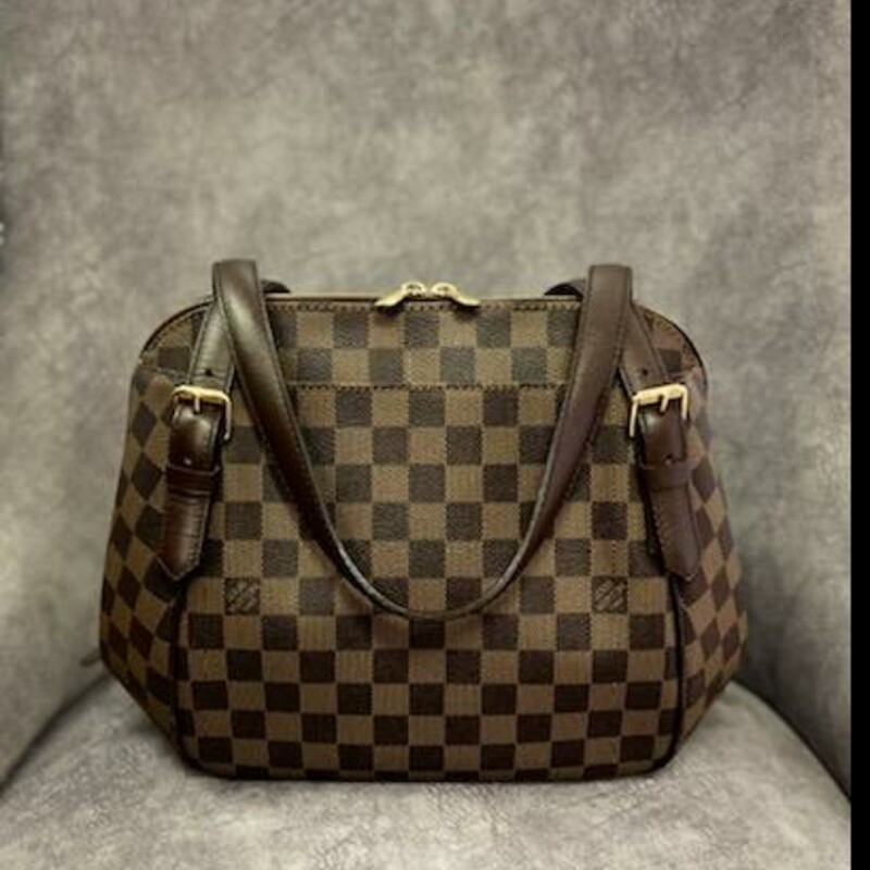 LOUIS VUITTON
Damier Ebene Belem MM
Craving a bag that is chic and feminine? This unique, curvy-shaped Louis Vuitton Damier Canvas Belem MM Bag is the one for you. It features a sleek structured design and two outer pockets for added convenience. This MM bag is the larger size of the Belem family and has the capacity to hold all your girly essentials and definitely will not cramp your style.
The original Louis Vuitton Damier Canvas was originally created in 1888 and was relaunched in 1996 with an entire collection of handbags and small leather goods. Its unique geometric pattern and understated elegance makes this a LV classic and timeless collection.
This stylish shoulder bag is crafted of Louis Vuitton's signature Damier checkered canvas in ebene brown. The bag features high patch pockets on front and back and dark brown leather straps with brass anchors. The top wrap-around zipper opens to an interior of red fabric interior.
Size (HxWxD): 24cm x 34cm x 15cm / 9.44'' x 13.38'' x 5.9''
Strap Length: 62.5cm / 24.6''
This is in like new condition.  Spotless inside and no exterior flaws.
Comes with CERTIFICATE of AUTHENTICITY
In this similar condition \"Rebag\" has this bag for $1665.00 & \"Tradesy\" is selling it for $1759.00.