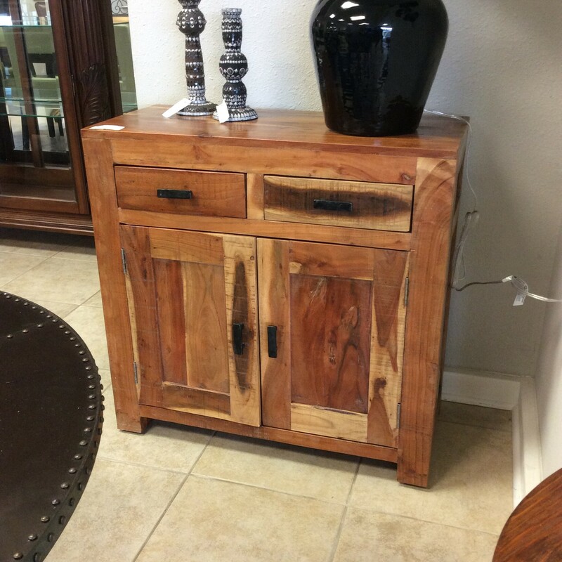 This cabinet is made of mango wood. It includes 2 drawers and a shelf behind cabinet doors.