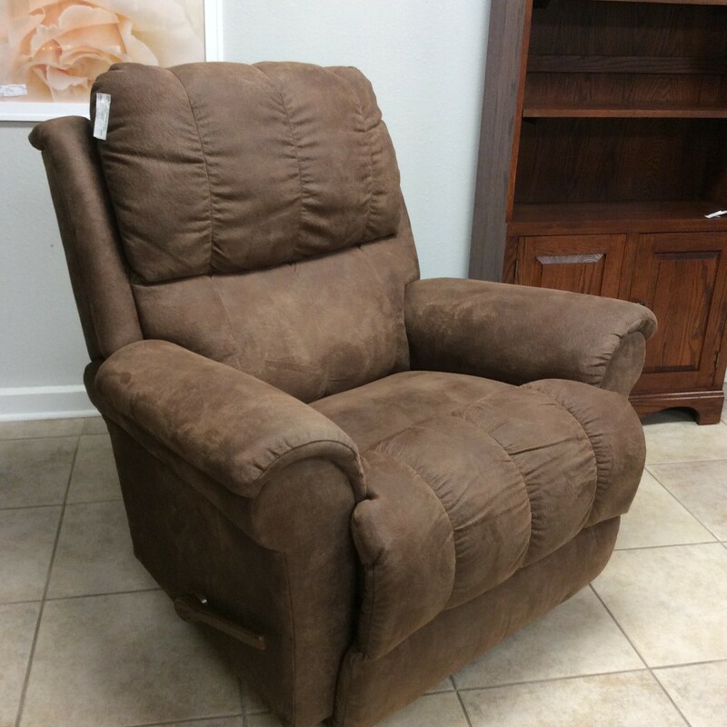 This recliner by Lazyboy is oversized and tufted. Upholstered in leather and it rocks as well.