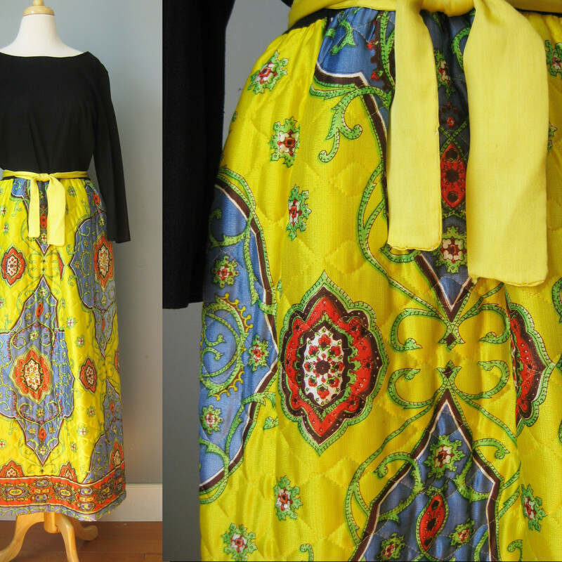 This 1970s maxi dress was made by Montgomery Ward (aka Sears)  It's a budget friendly version of a style that was so popular with hostesses in the 1970s.  It lent a kind of boho glam to suburban patio entertaining.  This one is made of synthetic materials.  the top is a black kint, not stretchy, a little rough to the touch,  it has an open round neckline.  The skirt is made of a thickish quilted yellow and blue large scale paisley satin.

Center back metal zipper
Should fit a modern size medium, please use measurements provided to be sure.
Flat measurements:
Shoulder to shoulder 17
Armpit to Armpit: 19.25
Waist: 16.75
Hip: up to 23
Length :  55
underarm sleeve seam: 14
Excellent condition, with a little bit of fading along the edge of the sleeves from light exposure.
Thank you for looking!
#39400