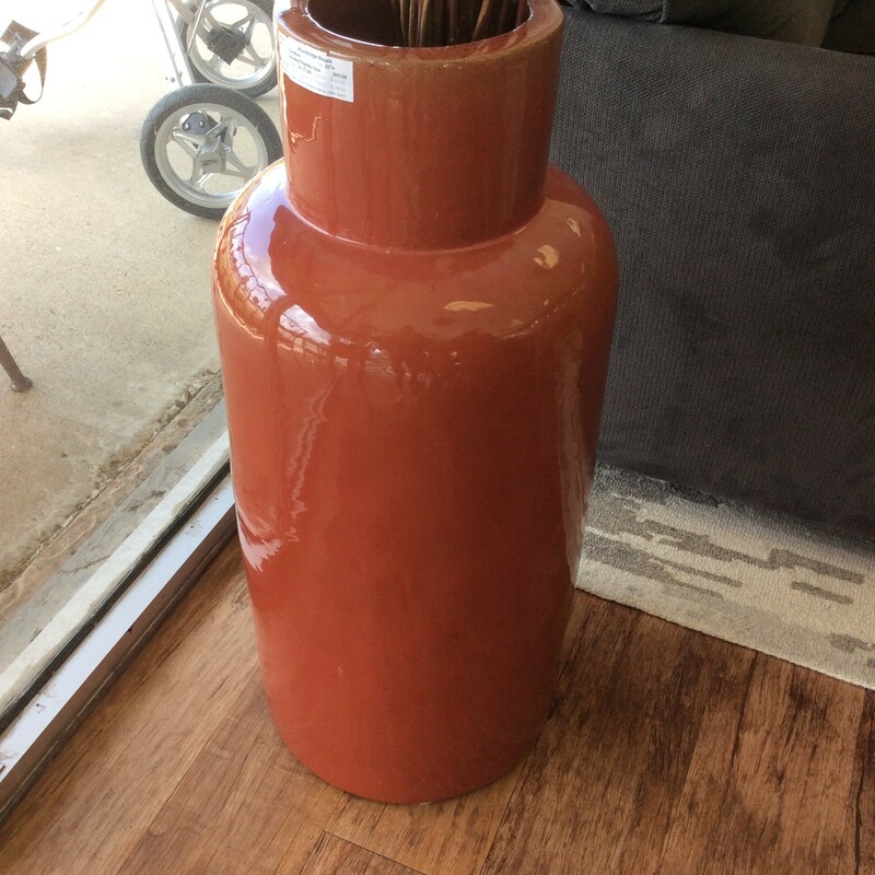 This tall vase has been painted a smoked paprika and measures 33\" in height.