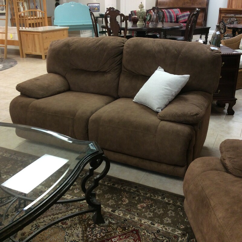 This double reclining loveseat is originally from Ashley. It's been upholstered in a brown microsuede and has manual operationl.
