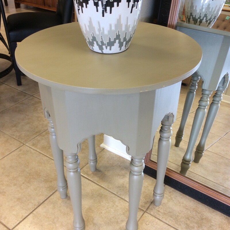 This side table has been painted taupe and has 6 legs.