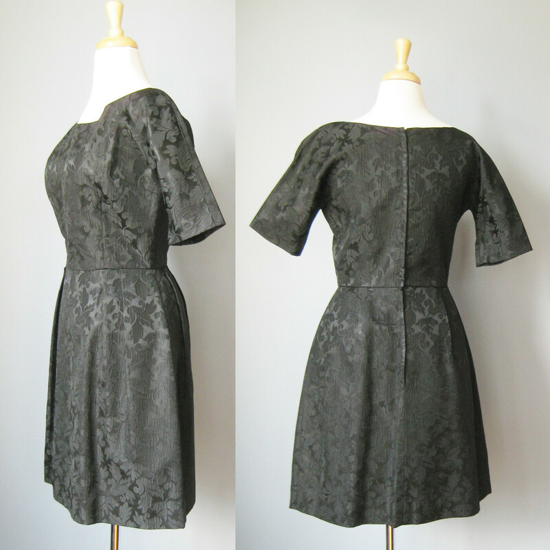 Classic LBD from the 1960s in a very fine black brocade.  The dress has a fitted bodice with almost elbow length sleeves, a defined waist and a fuller skirt supported by medium weight interfacing fabric (which isn't in the greatest shape unfortunately).  Center back zipper<br />
<br />
This dress seems to have been cut for a petite gal, based on the the length and the chest size.<br />
<br />
No tags<br />
flat measurements:<br />
armpit to armpit: 17.5<br />
waist: 14<br />
hip: 20<br />
length: 36.5<br />
underarm sleeve seam length: 5<br />
<br />
thanks for looking!<br />
#38879