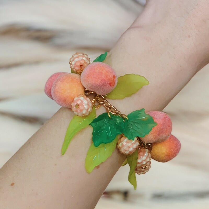 These pach bracelets are absolutely adorable! Handmade by Kelli Hawk Designs, they feature peach charms alongside peach colored beads. This is all on a gold 7 inch chain!
