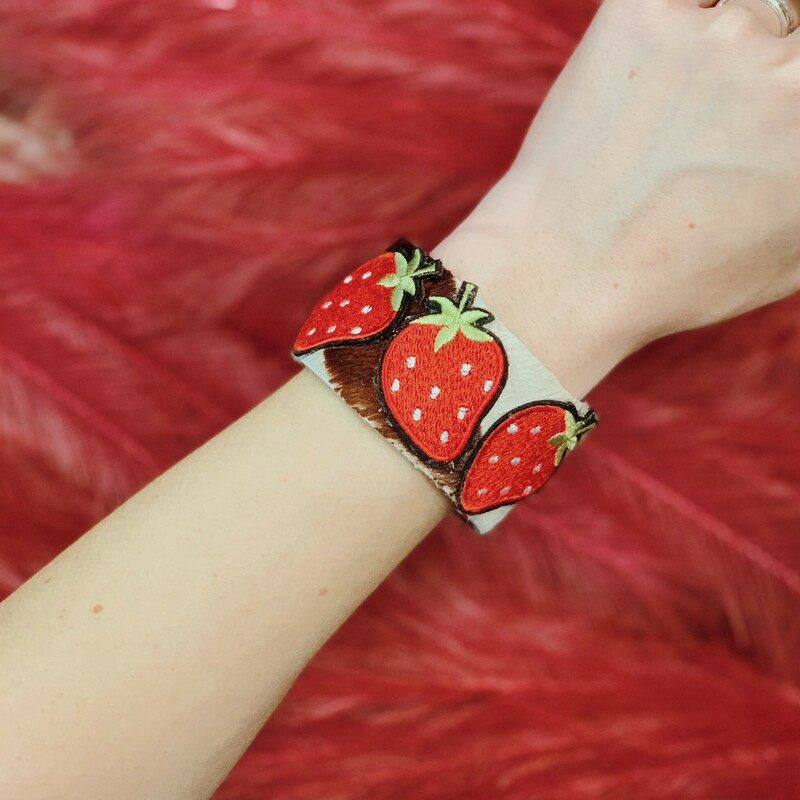 These cowhide strawberry cuffs are absolutely adorable! Handmade by Kelli Hawk Designs, these cuffs have a layer of leather cowhide over the front and three bright strawberries on top!