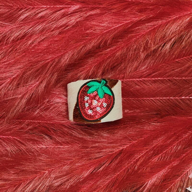 This cowhide strawberry cuff is absolutely adorable! Handmade by Kelli Hawk Designs, this cuff has a layer of leather cowhide over the front and three bright strawberries on top!