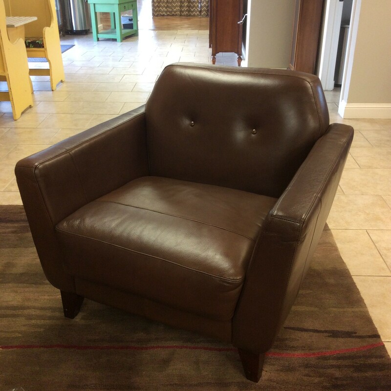This chair is modern with bold but sleek, cool lines. Upholstered in a soft and supple dark brown leather.