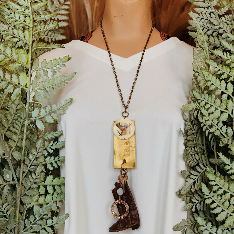 This one of a kind, handmade necklace is on a 25 inch long chain and features a brass plaque with a horse on it and a cowboy boot hanging below!