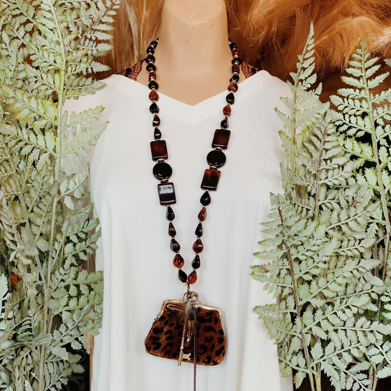 This one of a kind, handmade necklace is on a 34 inch long beaded strand and features the most amazing, vintage cheetah print coin purse as the centerpiece!