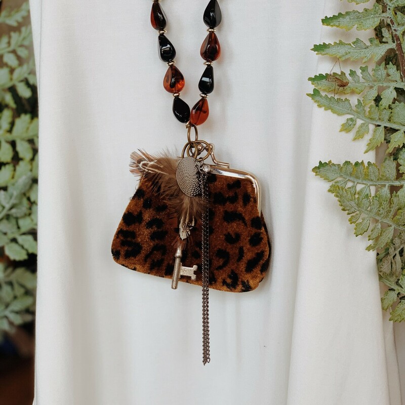 This one of a kind, handmade necklace is on a 34 inch long beaded strand and features the most amazing, vintage cheetah print coin purse as the centerpiece!