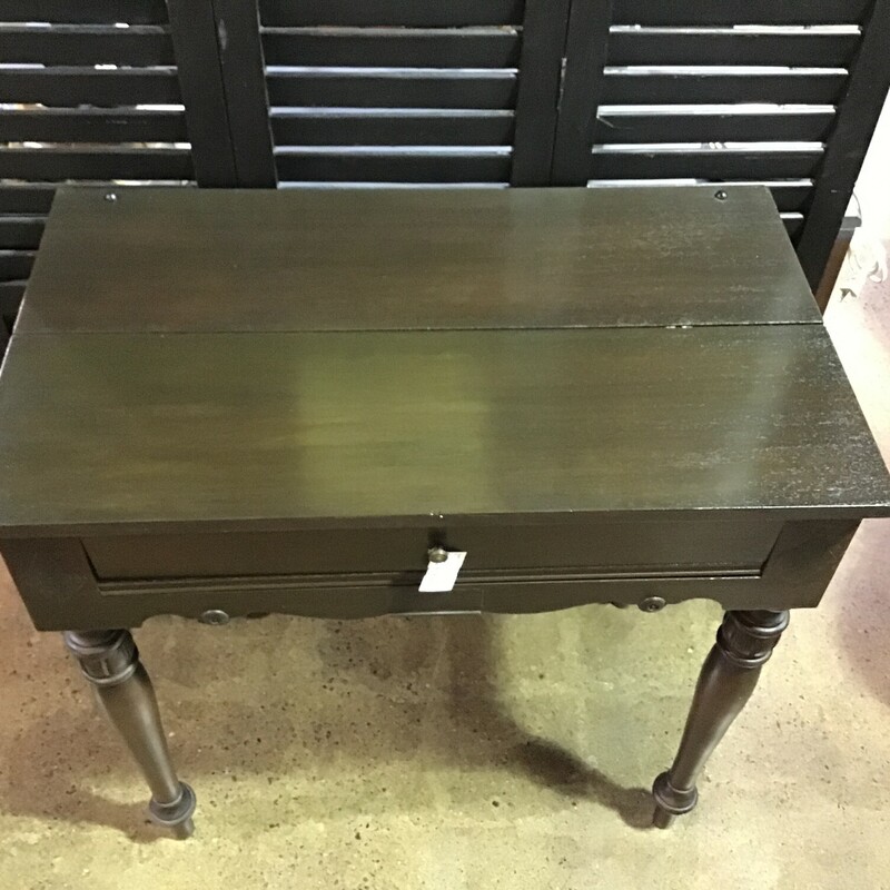 What a cute little desk!  This awesome wooden desk is great for smaller spaces.  It features a pull out writing surface and a flip down lid to close it when you are not using it.  There is a little drawer and some cubbies.

Dimensions:34 x 20 x 33
.