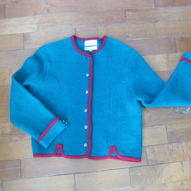 Nice warm cardigan by Tally Ho.
It's boiled wool with interesting details
Round silver metal buttons
Red contrast trim, notched hemline
100% wool
Excellent condition
Marked Size 6, but better for a modern size medium.
Here are the flat measurements, please double where appropriate:
shoulder to shoulder: 17.5
Armpit to armpit: 20
width at hem when buttoned: 17.25
underarm sleeve seam: 16
Overall length: 20.25

Thanks for looking!
#42041