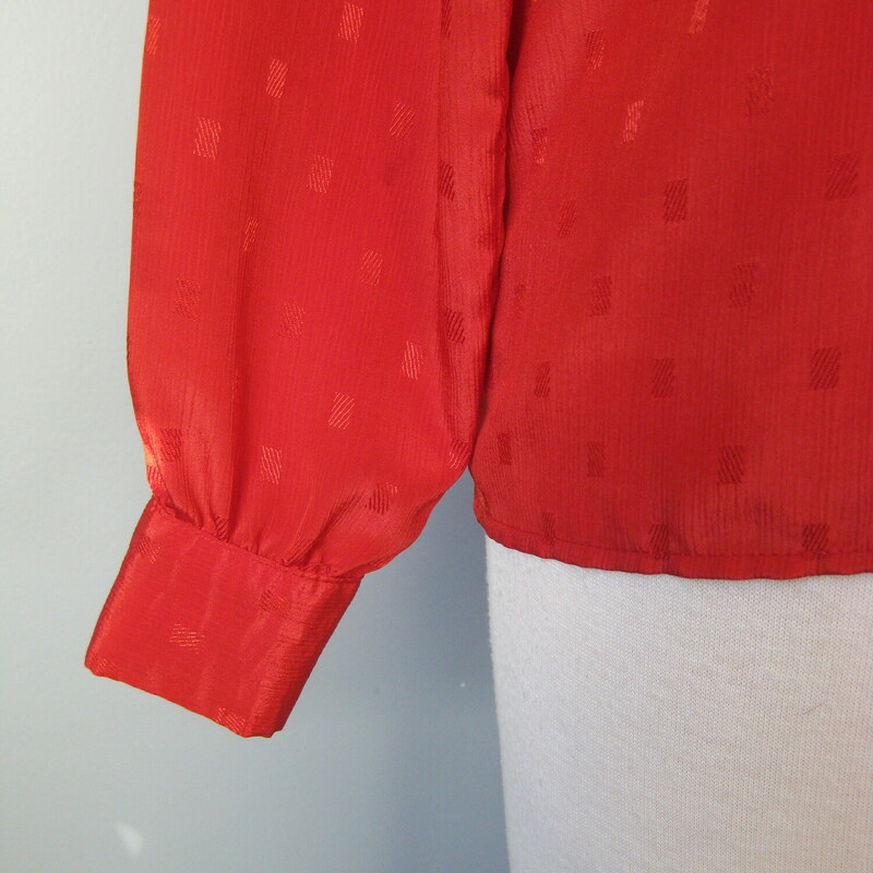 Great staple for the vintage wardrobe. This polyester jacquard blouse has long sleeves with button cuffs and a removeable sash at the neck. Hidden button placket.
The color bright true red.
No tags
Flat measurements, please double where approrpriate:
Shoulder to Shoulder : 15.5
Underarm sleeve seam length: 17 1/4
Armpit to Armpit: 19
Width at bottom: 19
Overall length: 24 1/4
Excellent condition!

thank for looking!
#41194