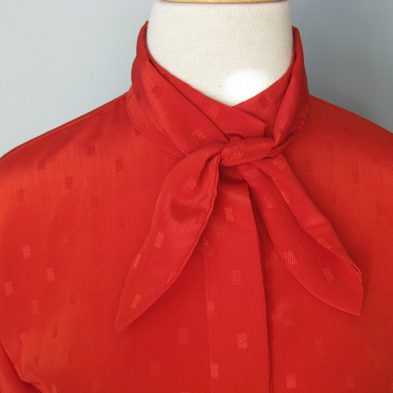 Great staple for the vintage wardrobe. This polyester jacquard blouse has long sleeves with button cuffs and a removeable sash at the neck. Hidden button placket.<br />
The color bright true red.<br />
No tags<br />
Flat measurements, please double where approrpriate:<br />
Shoulder to Shoulder : 15.5<br />
Underarm sleeve seam length: 17 1/4<br />
Armpit to Armpit: 19<br />
Width at bottom: 19<br />
Overall length: 24 1/4<br />
Excellent condition!<br />
<br />
thank for looking!<br />
#41194