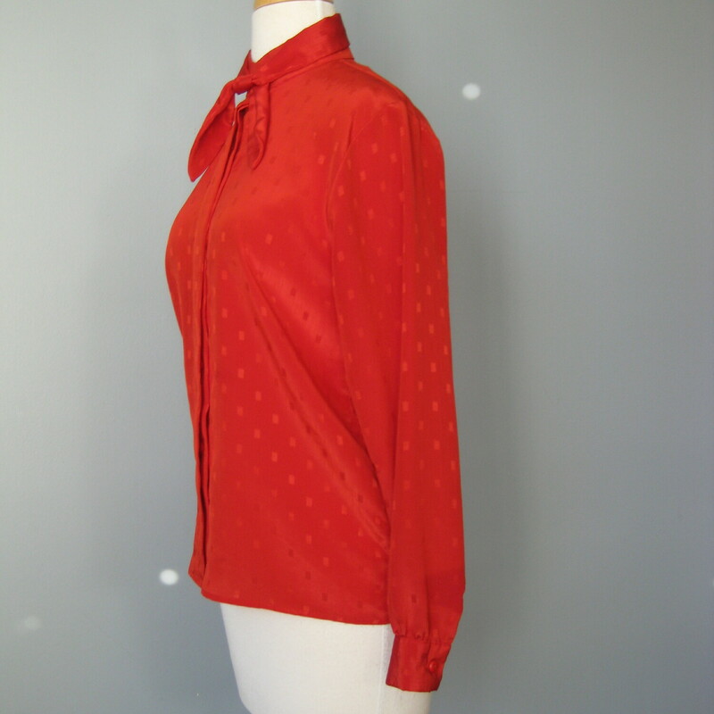 Great staple for the vintage wardrobe. This polyester jacquard blouse has long sleeves with button cuffs and a removeable sash at the neck. Hidden button placket.
The color bright true red.
No tags
Flat measurements, please double where approrpriate:
Shoulder to Shoulder : 15.5
Underarm sleeve seam length: 17 1/4
Armpit to Armpit: 19
Width at bottom: 19
Overall length: 24 1/4
Excellent condition!

thank for looking!
#41194