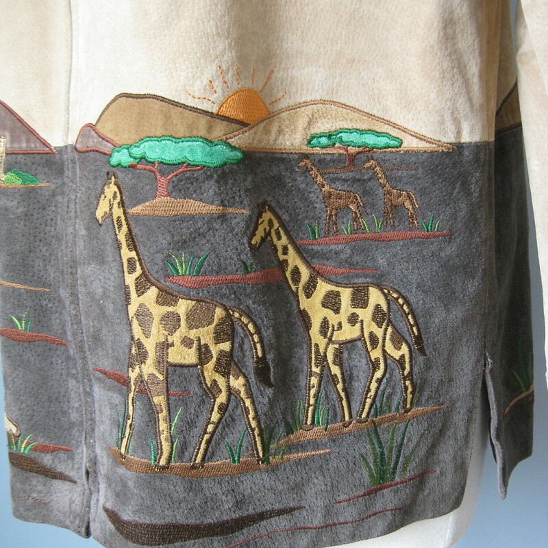 Charming jacket with beautifully rendered scenes from the African Savannah.<br />
It's suede, made from pigskin by Quacker Factory.<br />
<br />
This coat has a low nap suede feel and the skins, as is typical for pigskin, is a little stiff.<br />
It's covered with beautifully rendered, perhaps a little idealized, peacefull African Savanna scenes featuring, giraffe, elephant, cheetah.<br />
<br />
Lined, zip closure<br />
<br />
Interior flat measurements of the garment:<br />
shoulder to shoulder: 17<br />
armpit to armpit: 22<br />
width at hem: 21 3/4<br />
underarm sleeve seam: 18<br />
length: 28.5<br />
<br />
Thanks for looking!<br />
#42822