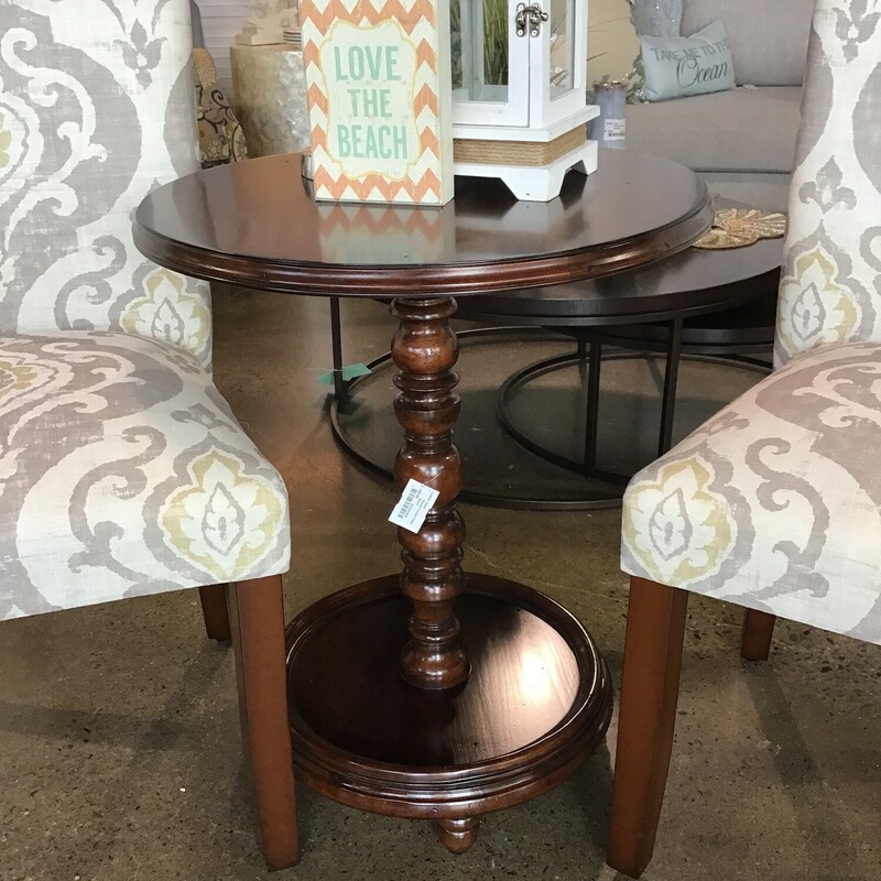 This beautiful wooden accent table features a round top, turned center leg and round base. It is a deep dark brown and would be perfect between 2 chairs or next to a sofa, loveseat or bed.
Dimensions are 22 in x 26 in