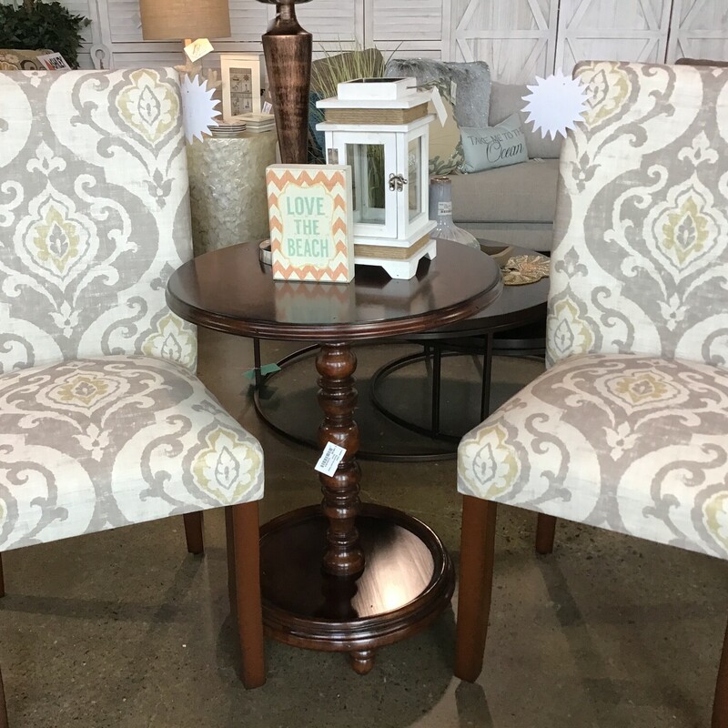 This beautiful wooden accent table features a round top, turned center leg and round base. It is a deep dark brown and would be perfect between 2 chairs or next to a sofa, loveseat or bed.

Dimensions are 22 in x 26 in