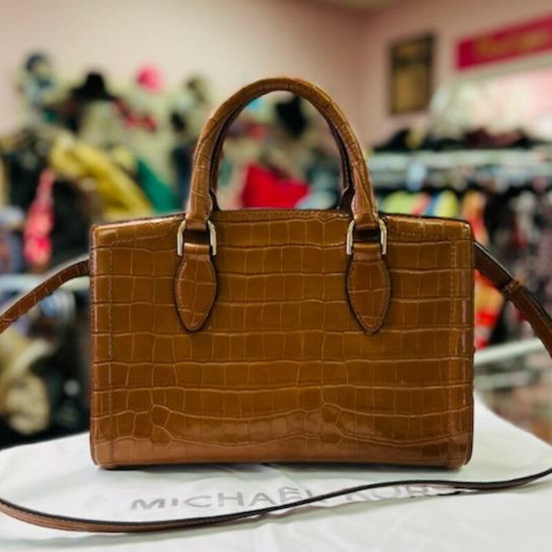 MICHAEL KORS - Zoe Satchel<br />
A refined silhouette accented with classic croc-embossed leather and two ways to carry. It's no wonder we're head over heels for Michael Michael Kors' Zoe satchel!<br />
11-1/2\"W x 8\"H x 5-1/2\"D (width is measured across the bottom of handbag); 2.01 lbs. approx. weight<br />
Silhouette is based off 5'9\" model<br />
4\"L handles; 20-3/4\"L strap<br />
Snap closure<br />
18K gold-tone exterior hardware<br />
1 interior zip pocket & 2 slip pockets<br />
color:  Chestnut<br />
Dust bag included<br />
Original Retail Price:  $398.00<br />
This bag is in LIKE NEW CONDITION!<br />
I LOVE THIS BAG - all leather!  A MUST SEE!