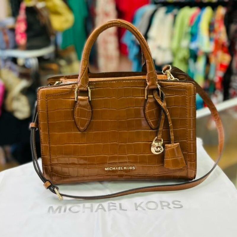 MICHAEL KORS - Zoe Satchel
A refined silhouette accented with classic croc-embossed leather and two ways to carry. It's no wonder we're head over heels for Michael Michael Kors' Zoe satchel!
11-1/2\"W x 8\"H x 5-1/2\"D (width is measured across the bottom of handbag); 2.01 lbs. approx. weight
Silhouette is based off 5'9\" model
4\"L handles; 20-3/4\"L strap
Snap closure
18K gold-tone exterior hardware
1 interior zip pocket & 2 slip pockets
color:  Chestnut
Dust bag included
Original Retail Price:  $398.00
This bag is in LIKE NEW CONDITION!
I LOVE THIS BAG - all leather!  A MUST SEE!